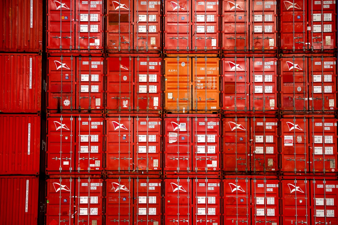 a-large-amount-of-red-containers-stacked-on-top-of-each-other-kclmlbxp6w0